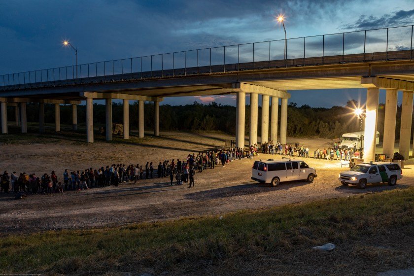 As the sun sets near McAllen TX, migrants that have crossed the Rio Grande surrender to U.S. Border Patrol near an area known as Rincon.